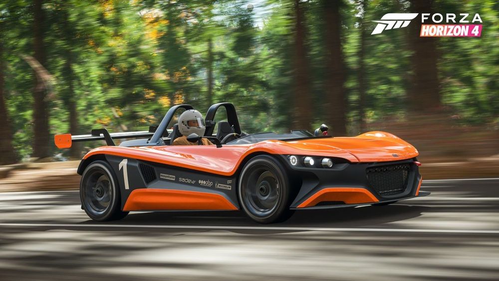 Orange topless sports car driving through a forest road.