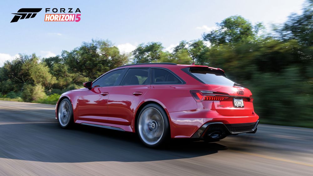 Audi RS 6 Avant from the side driving on an asphalt road