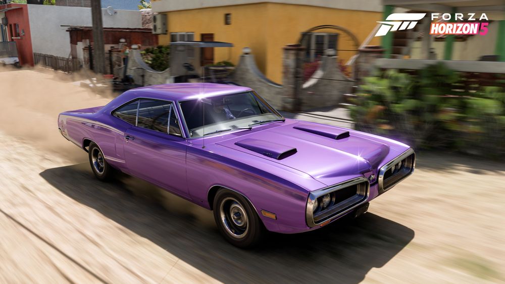 Purple antique race car driving through the streets of Mexico.