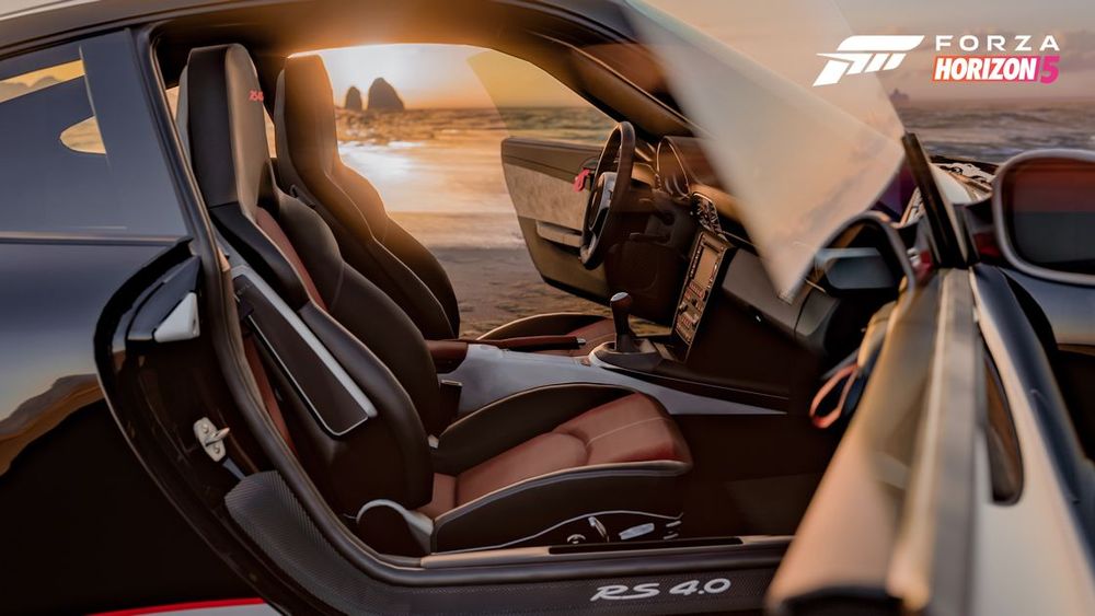 The doors of a black Porsche 911 GT3 open with a sunrise visible in the background.