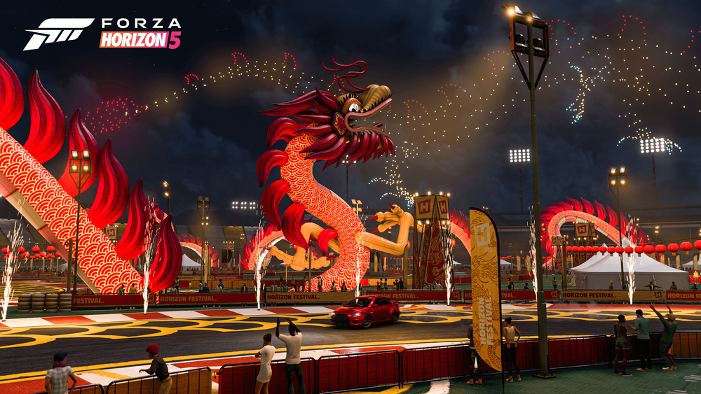 Dragon prop standing on a race track with lights in the night sky