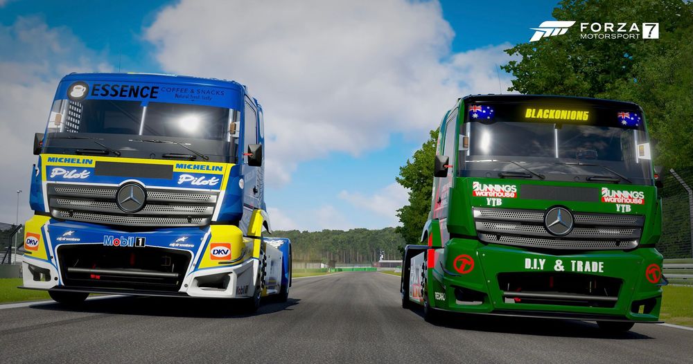 Two racing trucks line up on track