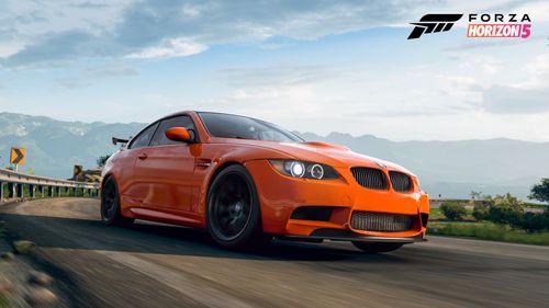 An orange BMW M3 GTS drives through Horizon Mexico