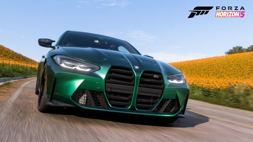 A green BMW M4 Competition Coupe drives toward the camera in FH5.