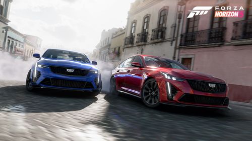 The red and blue Cadillac Blackwings create tire smoke through the streets of Guanajuato.