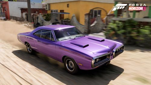 Purple antique race car driving through the streets of Mexico.