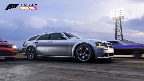 Dodge magnum driving alongside other cars.
