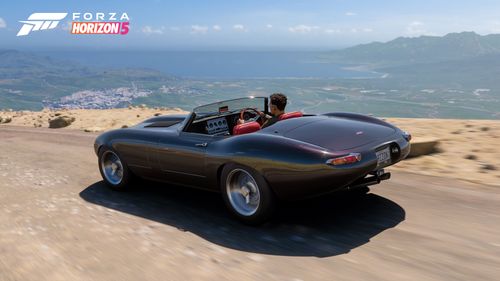 The black 2012 Eagle Speedster drives from the volcano with a stunning view of the Mexican landscape adorning it.