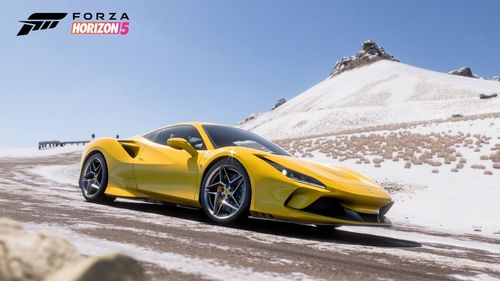 Yellow Ferrari F8 Tributo on a snowy road.
