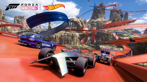 Several Hot Wheels vehicles including a purple Deora and purple Baja Boneshaker are led by a silver Bad to the Blade single-seater race car. They drive together towards the camera while surrounded by a web of blue and orange tracks in the canyon biome.