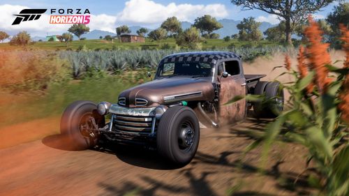 Ford F5 Dually Custom Hot Rod speeding down a dirt road of a farm.