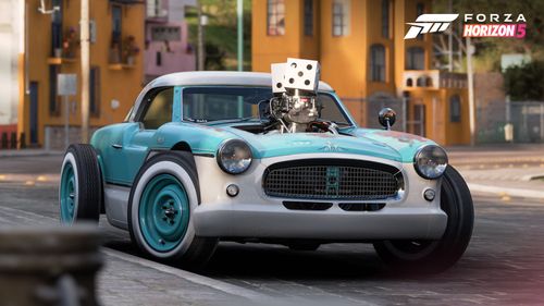 Front view of Nash Metropolitan car with its iconic dice on top of the partially exposed engine.