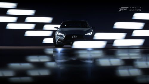 A Lexus is seen in the center of white lights on a black background.