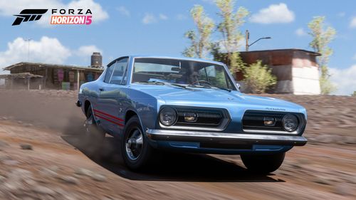 A blue Plymouth Barracuda Formula S kicks up dirt by drifting along the trail.