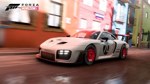Porsche #70 Porsche Motorsport 935 driving inside the city