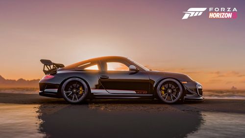 A side view of a black Porsche 911 GT3 with a sunset behind.