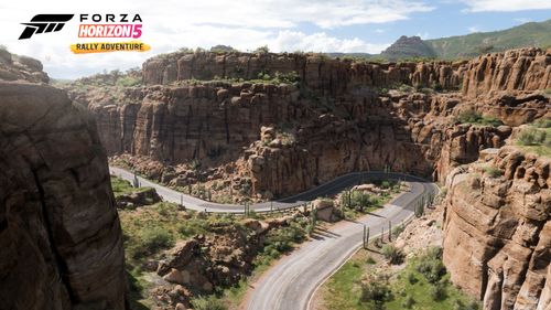 A u-shaped road in the Desert Gorge full of towering canyon rocks.