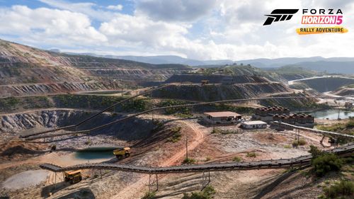 Abandoned Quarry featuring machinery, sloped terrain, piles of dirt and dump trucks.