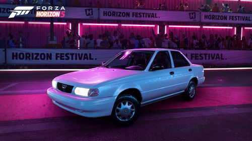 A Nissan Tsuru standing underneath purple and pink neon lights