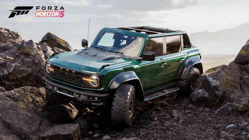 A green Ford Bronco Raptor parked on top of a rocky mountain 