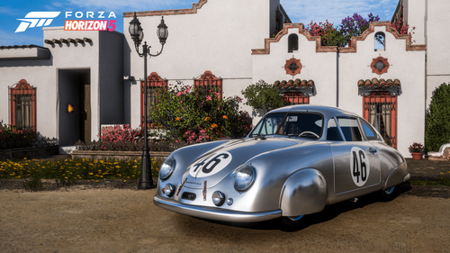 Silver retro Porsche labeled with the number 46 outside of a white house 