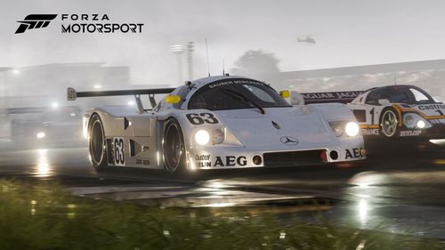 Silver 1989 Mercedes-Benz #63 Sauber-Mercedes C 9 racing in the rain at Silverstone alongside a purple and white 1988 Jaguar #1 Jaguar Racing XJR-9.