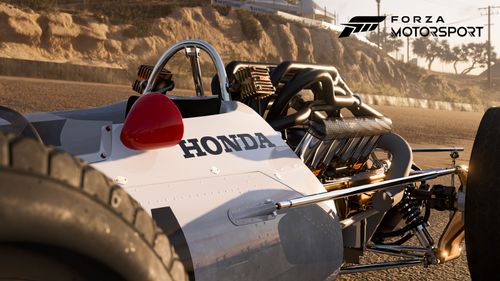 A close-up view of the engine in a classic Honda race car.