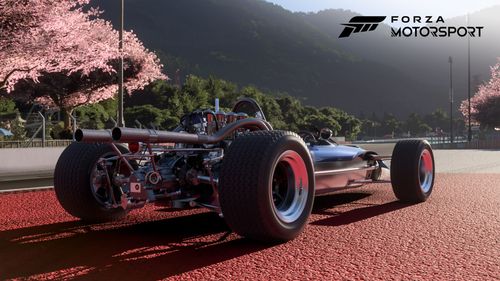 A Lotus race car parked on a curb on the Hakone race track