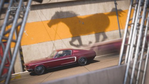 The shadow of a Mustang horse is cast on a wall behind a Mustang by Kerles