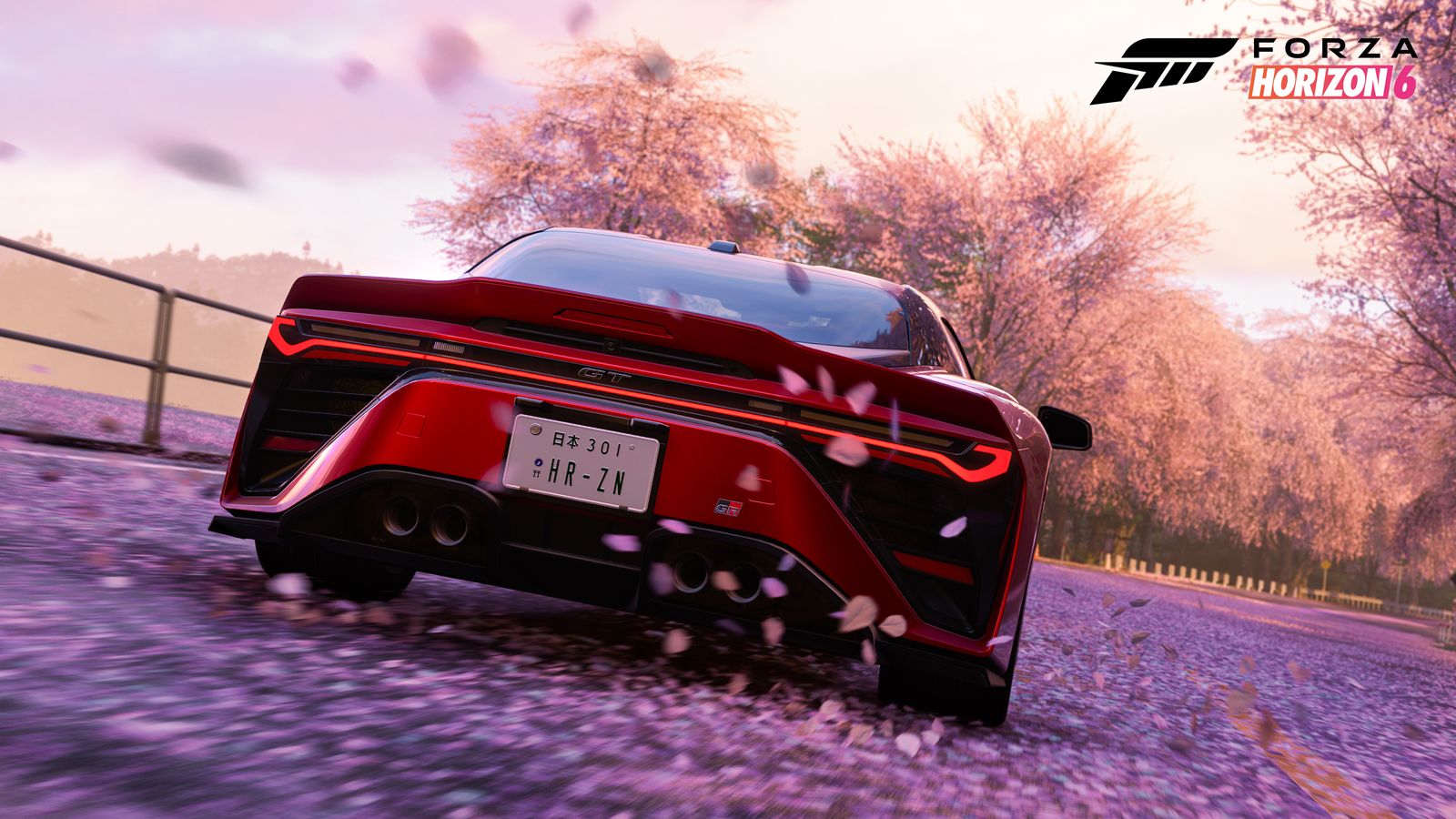 Un auto deportivo rojo avanza sobre pétalos de cerezo en Japón, en Forza Horizon 6